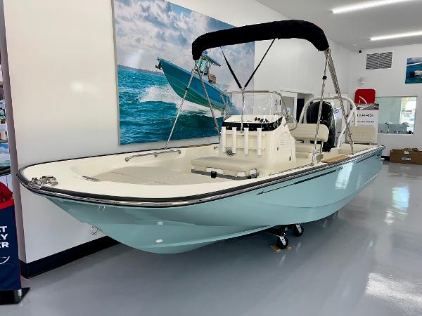Boston Whaler 170 Montauk 2025 Boston Whaler 170 Montauk boat displayed indoors with a sleek design and canopy.