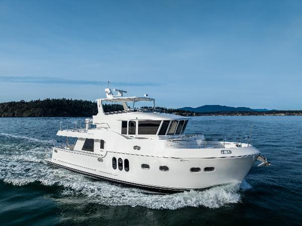 Northwest 55 Luxury Northwest 55 yacht cruising on open water, 2025 model, under clear blue skies.