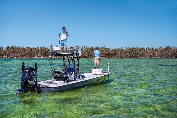 Yellowfin 24 Bay CE 2021 Yellowfin 24 Bay CE boat in shallow water with two people fishing.