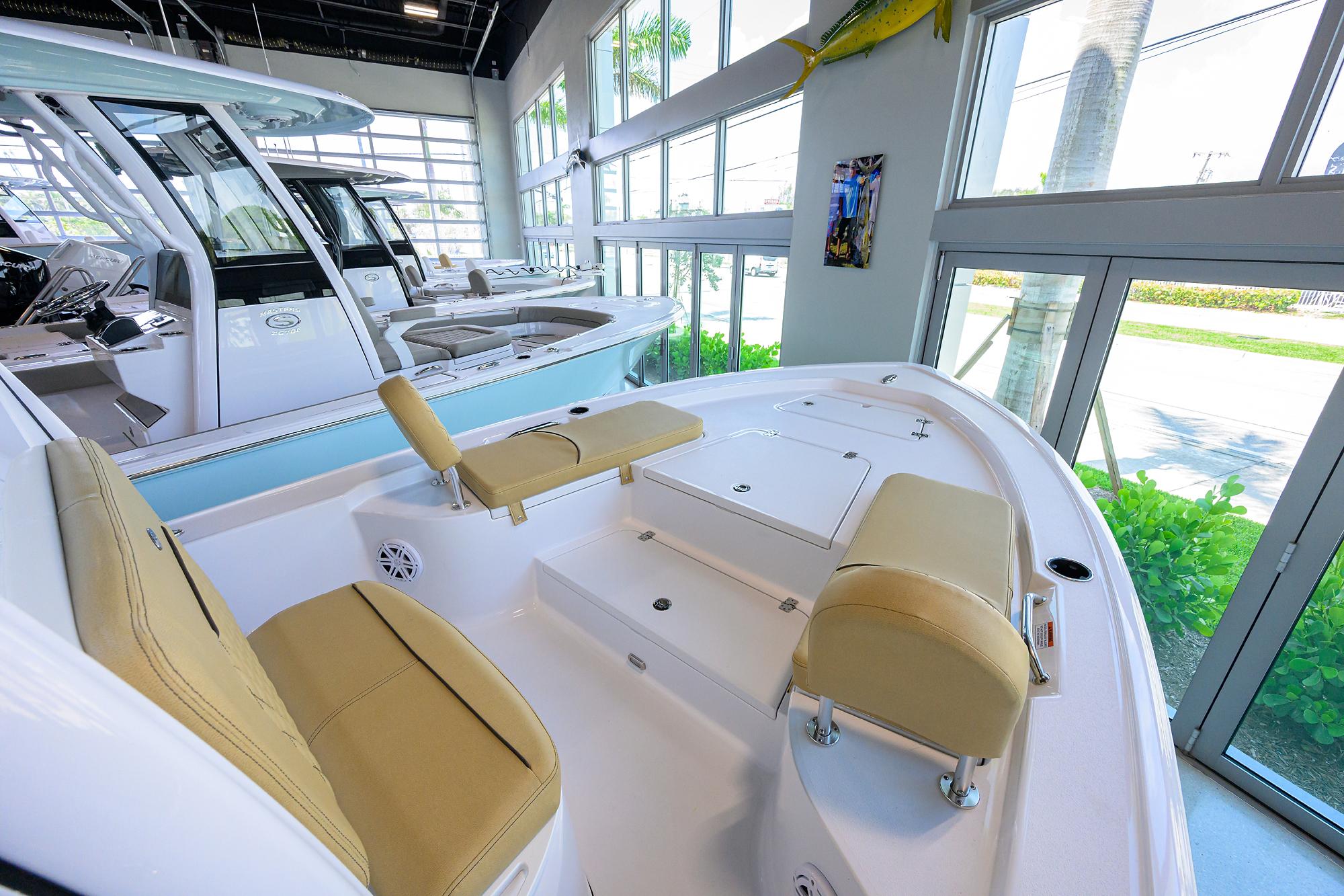 Sportsman Masters 227 Bay Boat 2025 Sportsman Masters 227 Bay Boat interior with beige seating in a showroom.