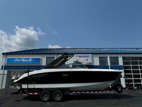 Sea Ray SDX 270 2025 Sea Ray SDX 270 boat on a trailer outside a dealership.