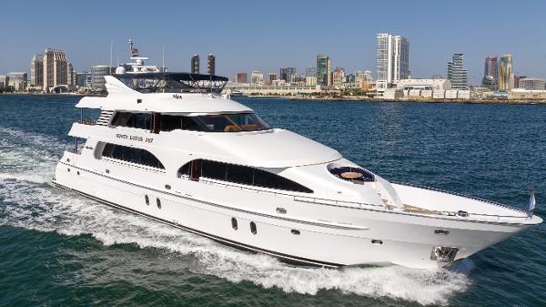 President Sterling 107 Co Ownership Luxurious 2011 President Sterling yacht cruising near city skyline.