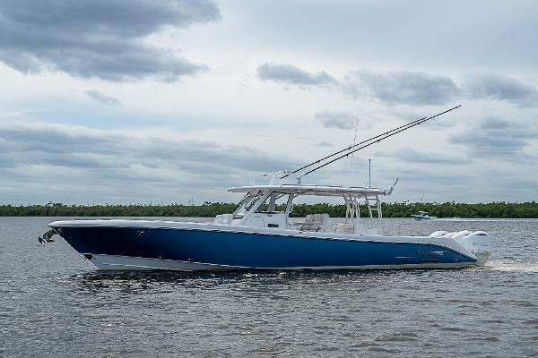 Everglades 435 Center Console 2018 Everglades 435 Center Console boat cruising on a calm, cloudy day.