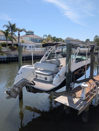Sea Ray SDX 250 Outboard 2022 Sea Ray SDX 250 Outboard boat docked in a scenic waterfront setting.