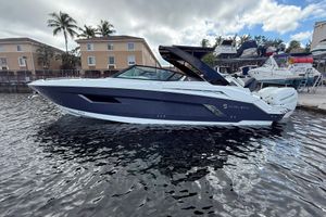 Cruisers Yachts 338 Outboard 2019 Cruisers Yachts 338 Outboard on water, with palm trees and buildings in background.