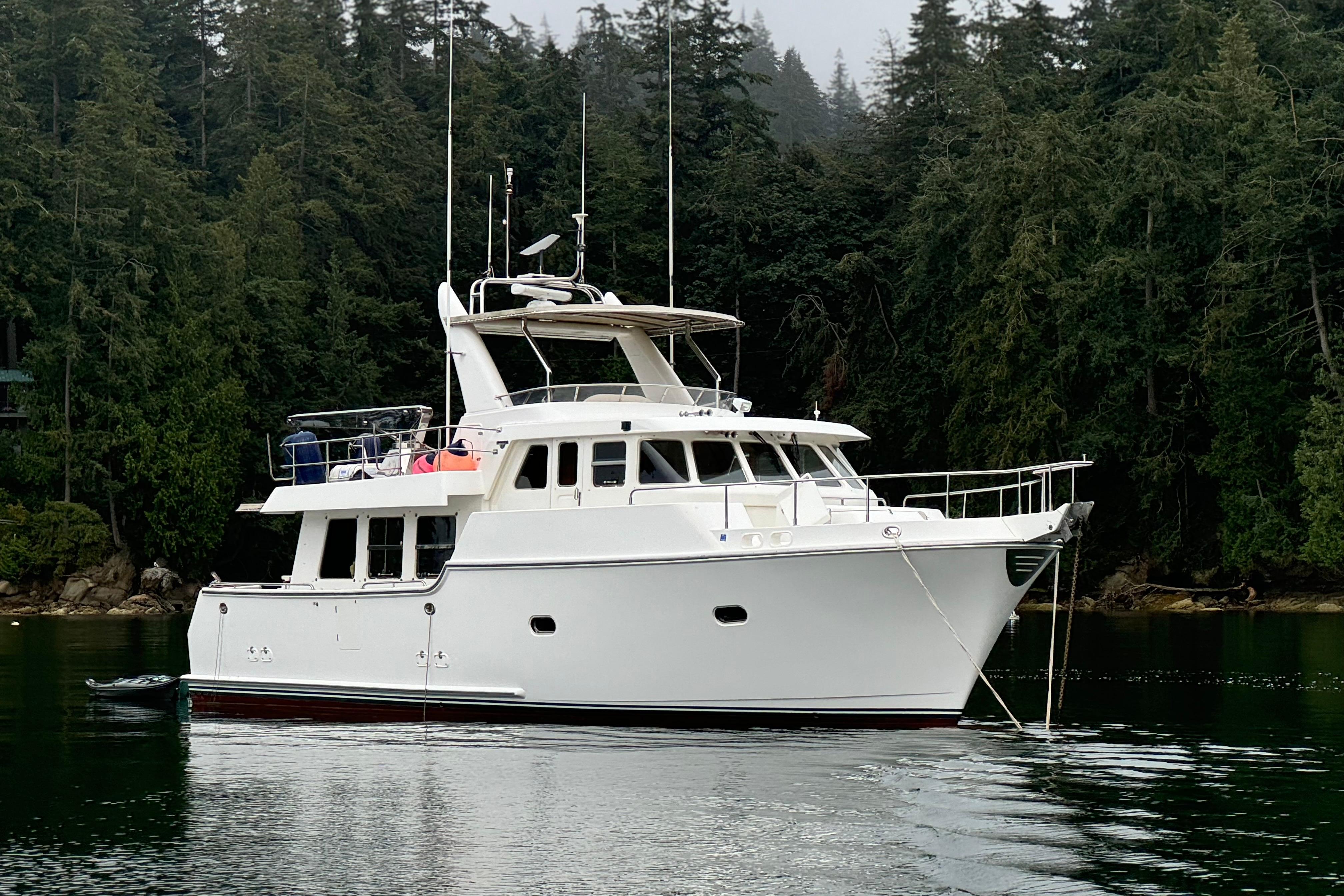 Nordhavn N50 2004 Nordhavn N50 yacht anchored in serene forested waters.