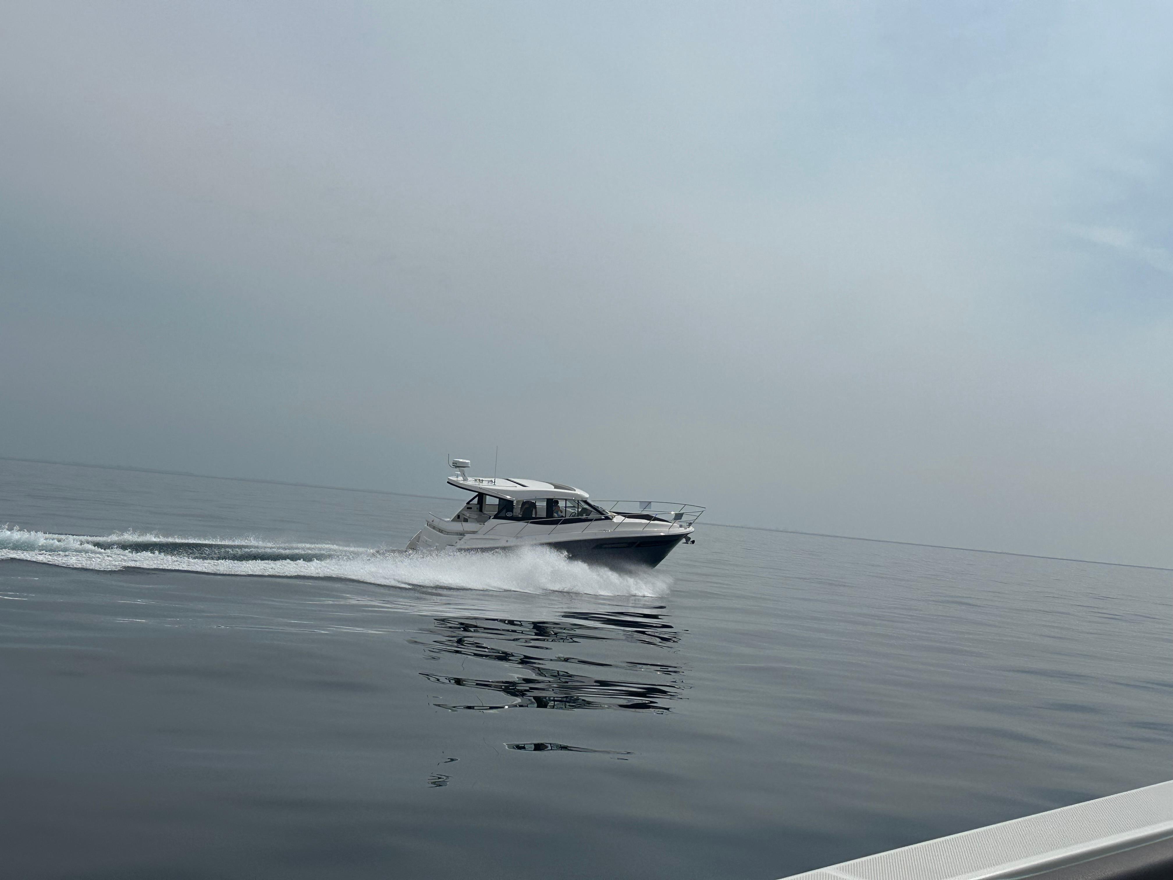 Regal 38 Grande Coupe 2025 Regal 38 Grande Coupe cruising on calm waters under a cloudy sky.