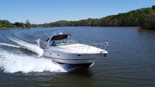 Cruisers Yachts 370 Express 2004 Cruisers Yachts 370 Express speeding on a scenic lake.