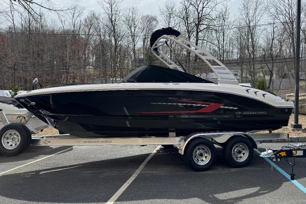 Chaparral 21 SSi 2025 Chaparral 21 SSi IO boat on trailer, parked outdoors.