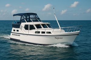 Boarncruiser 1000 Boarncruiser 1000 yacht cruising on open sea, 2000 model, under clear blue sky.