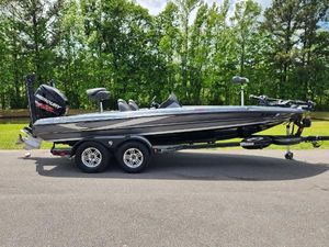 Triton 20 TrX 2018 Triton 20 TRX boat on trailer, parked outdoors with trees in background.