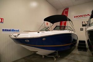 Four Winns HD3 OB 2023 Four Winns HD3 OB boat in showroom, blue hull, black canopy, Honda signage.