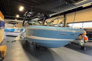 Chaparral SSX 6 2026 Chaparral 267 SSX boat in showroom, blue exterior, black canopy, modern design.