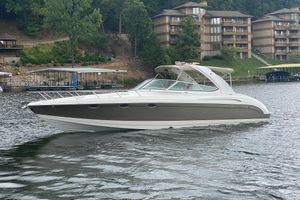 Formula 370 Super Sport 2004 Formula 370ss boat on a lake with waterfront buildings in the background.
