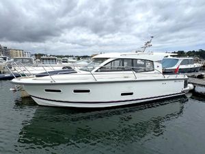 Nimbus 305 Coupe 2019 Nimbus 305 Coupe boat docked in a marina under cloudy skies.
