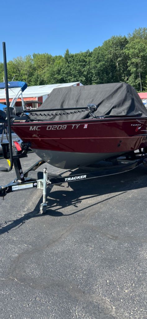 Tracker Targa V-18 Combo 2016 Tracker Targa™ V-18 Combo boat on trailer, covered, parked outdoors.