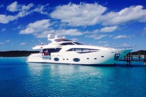 Custom Line 100 Luxurious 2014 Custom Line 100 yacht docked in clear blue waters under a bright sky.