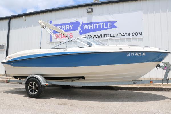Bayliner 215 Bowrider 2011 Bayliner 215 Bowrider boat on trailer, parked outside dealership.