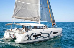 Excess EXCESS 11 2023 Excess EXCESS 11 catamaran sailing on open sea under clear blue sky.