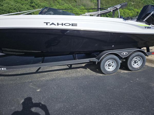 Tahoe T21 2024 Tahoe T21 boat on a trailer in a parking lot.