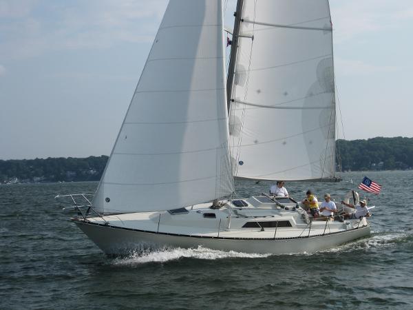 C&C 35 MKIII 1983 C&C 35 MKIII sailboat cruising on a lake with crew onboard.