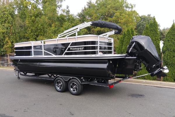 Ranger Reata 223C 2024 Ranger Reata 223C pontoon boat on trailer, parked on street.