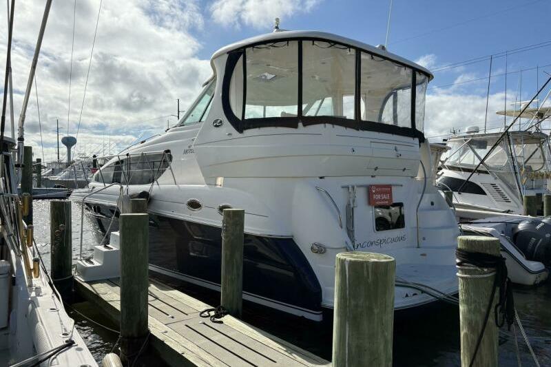 Sea Ray 40 Motor Yacht 2006 Sea Ray 40 Motor Yacht docked, for sale sign visible, under partly cloudy sky.