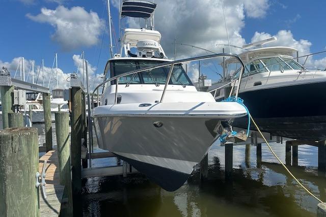 Everglades 320 EX with Tower 2011 Everglades 320 EX with Tower docked at marina under blue sky.