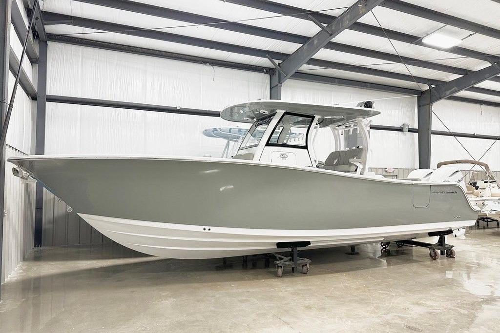Sportsman Open 302 Center Console 2025 Sportsman Open 302 boat in a showroom, featuring sleek design and modern amenities.