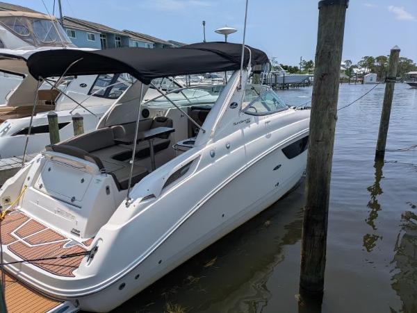 Sea Ray 280 Sundancer 2014 Sea Ray 280 Sundancer boat docked at marina with black canopy.