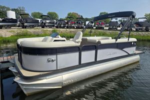 Manitou 21 Oasis RF 2019 Manitou 21 Oasis RF pontoon boat docked on calm water.