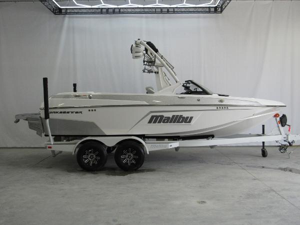 Malibu Wakesetter 20 VTX 2025 Malibu Wakesetter 20 VTX boat on trailer in showroom setting.