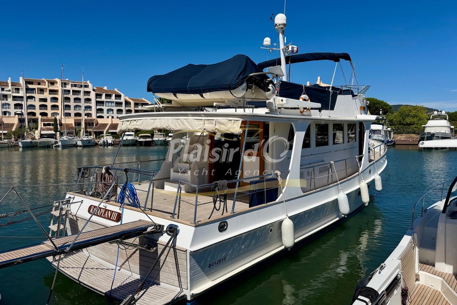 Grand Banks 52 Europa 2005 Grand Banks 52 Europa yacht docked in a marina under clear blue skies.