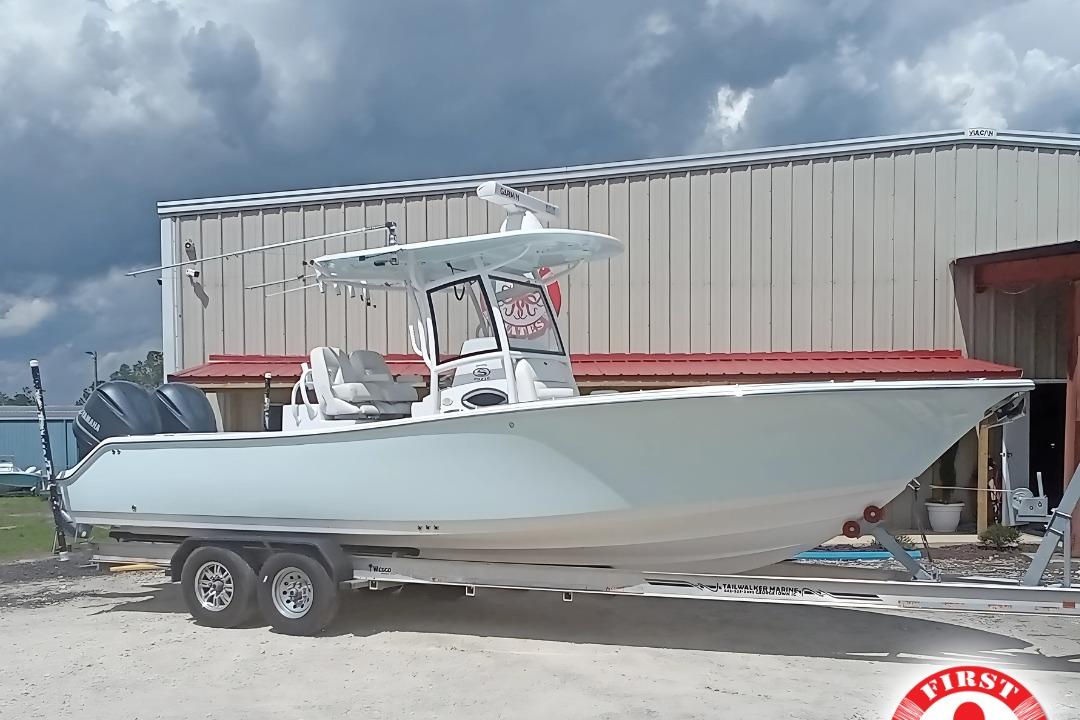 Sportsman Open 282TE Center Console 2020 Sportsman Open 282TE Center Console boat on trailer, parked outside a building.