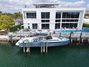Limitless Seas 45 XLV Luxury yacht Limitless Seas 45 XLV docked by modern waterfront mansion, 2023 model.