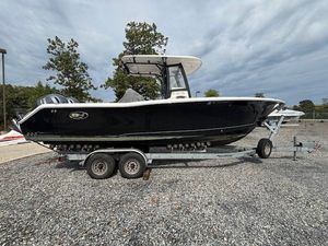 Sea Hunt Gamefish 27 2019 Sea Hunt Gamefish 27 boat on trailer, parked on gravel lot.