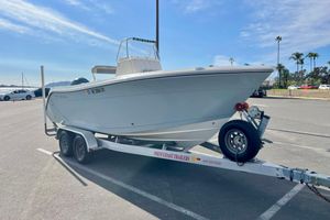 Cobia 201 Center Console 2018 Cobia 201 Center Console boat on trailer in sunny parking lot.