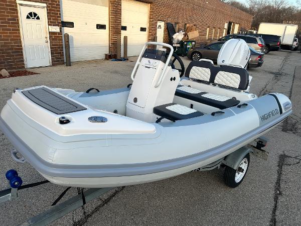 Highfield Sport 330 2023 Highfield Sport 330 inflatable boat on trailer, parked in an industrial area.
