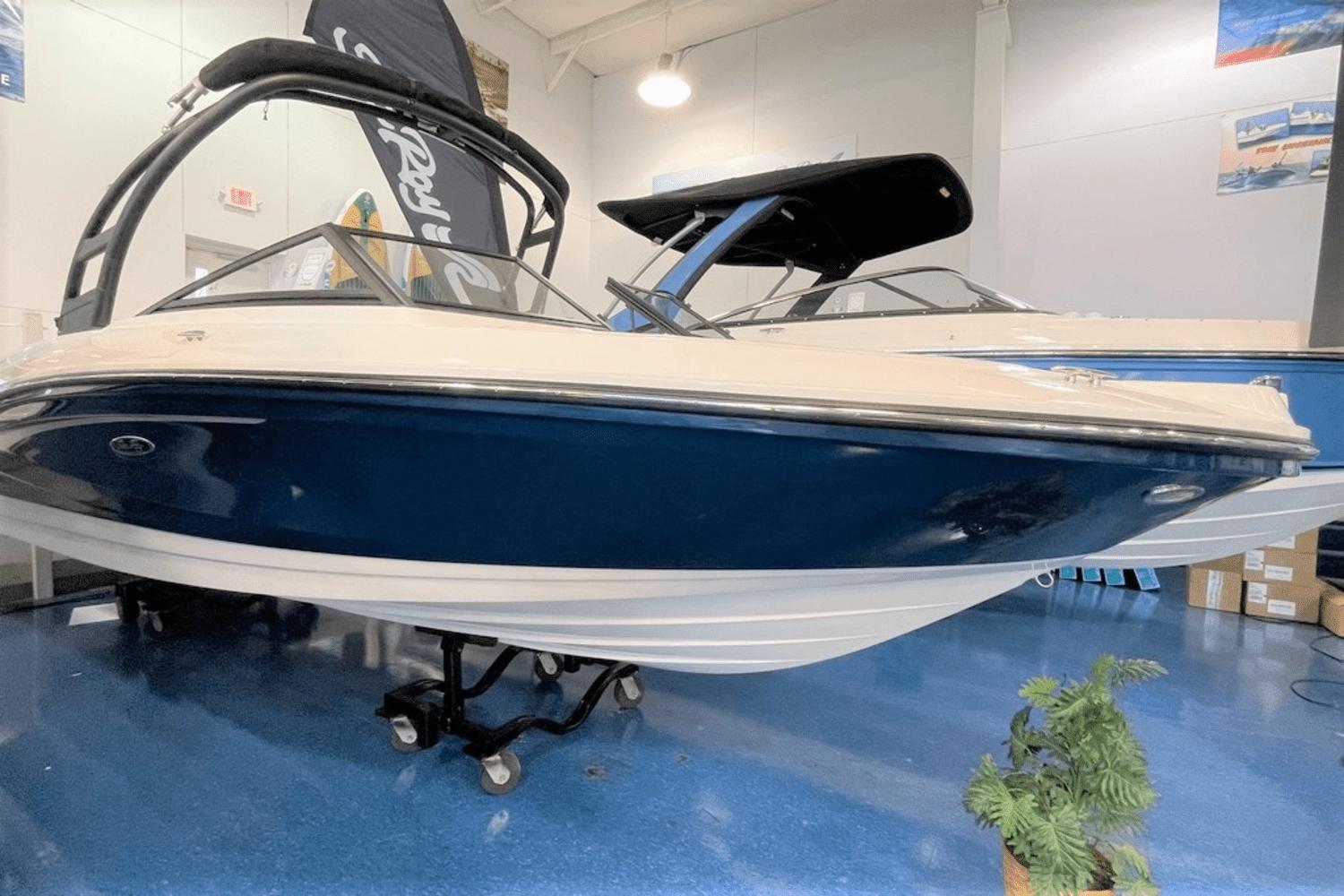 Sea Ray SPX 210 2023 Sea Ray SPX 210 boat on display in showroom.