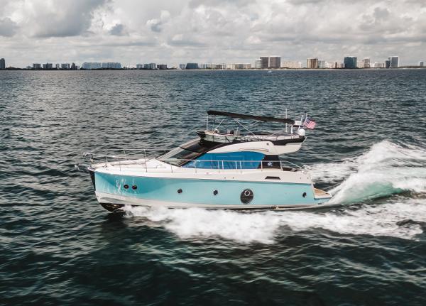 Beneteau Monte Carlo 5 2015 Beneteau Monte Carlo 5 yacht cruising on open water with city skyline in background.