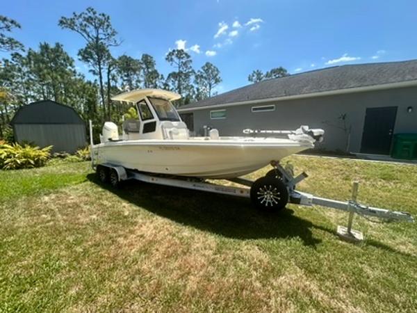 Scout 261 XSS 2025 Scout 261 XSS boat on trailer in sunny yard.