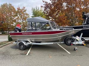 Spartan 18 Areus 2025 Spartan 18 Areus boat on trailer in parking lot, autumn trees in background.