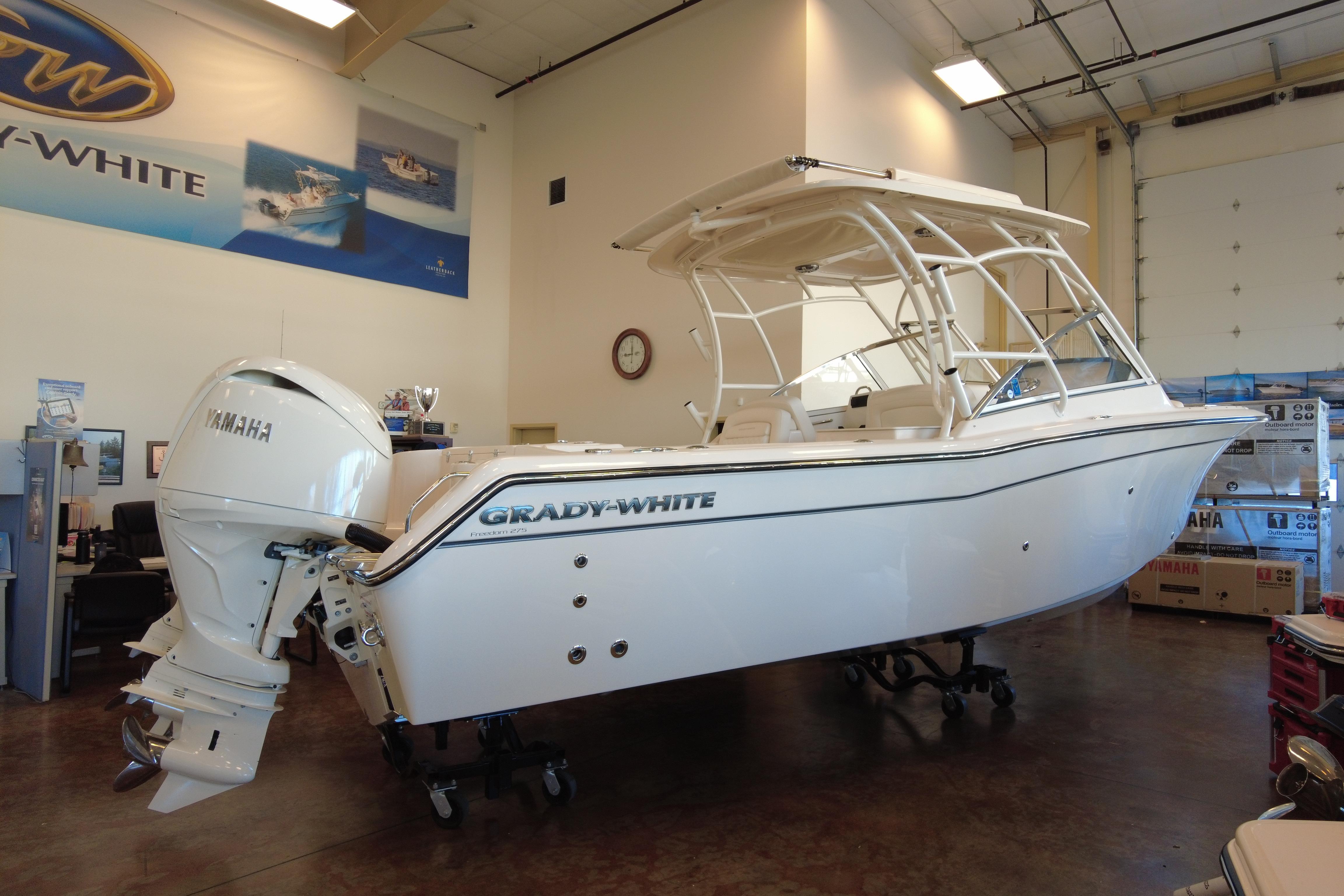 Grady-White Freedom 275 2025 Grady-White Freedom 275 boat displayed indoors with Yamaha engine.