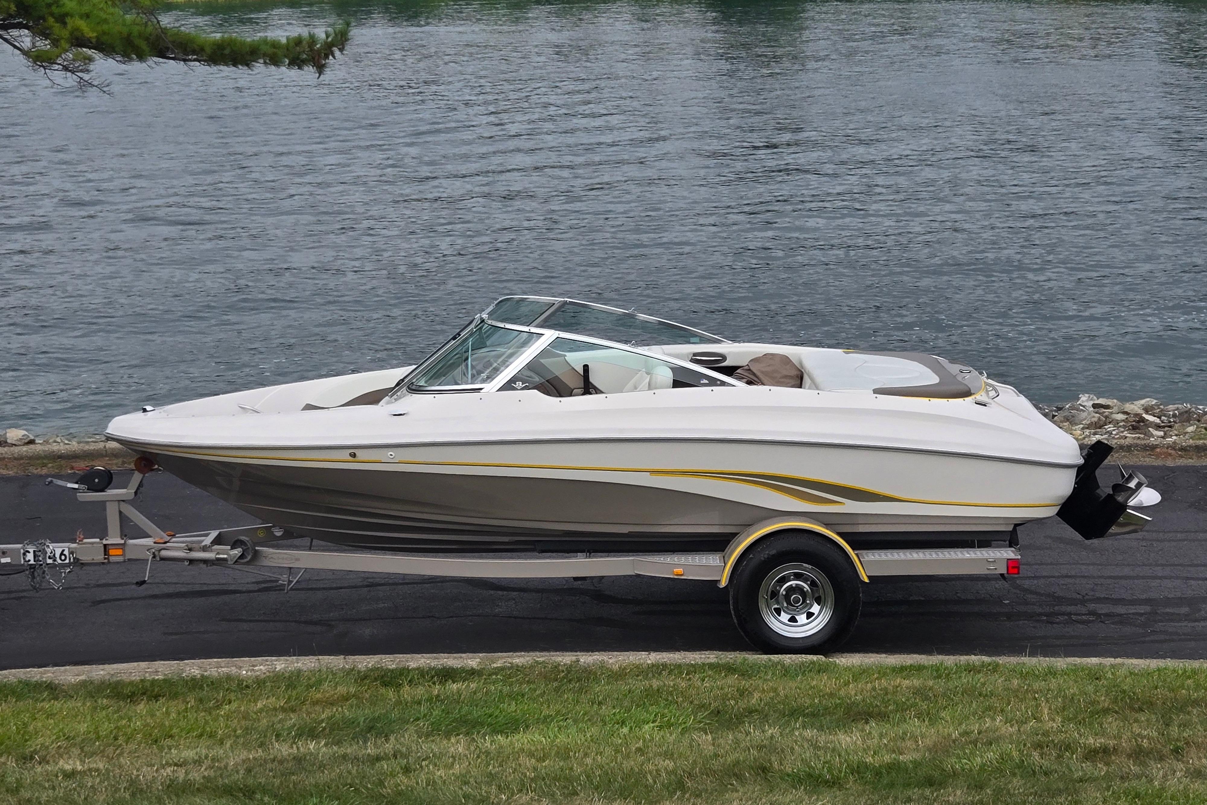 Tahoe Q5S I/O 2001 Tahoe Q5S I/O boat on trailer by a lake.