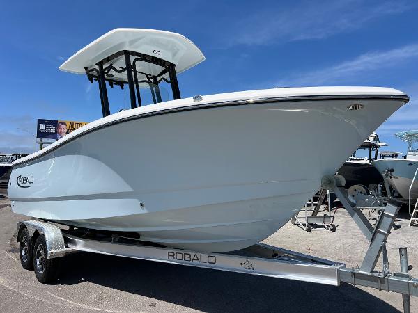 Robalo R232 Explorer 2025 Robalo R232 Explorer boat on trailer under clear blue sky.