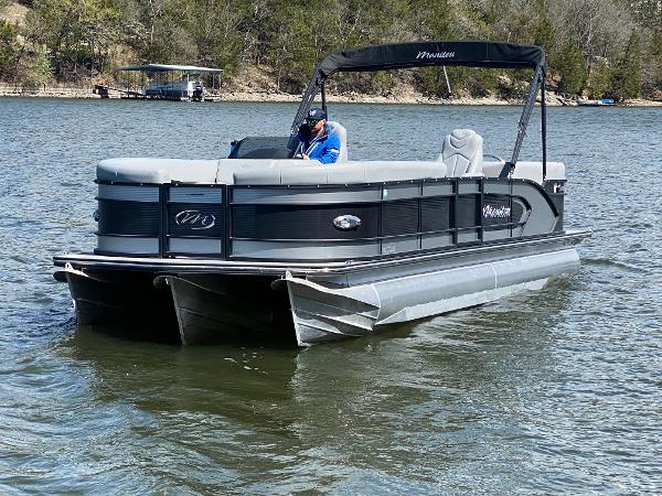 Manitou 25 Encore RF SHP Twin 2021 Manitou 25 Encore RF SHP Twin pontoon boat on a lake.