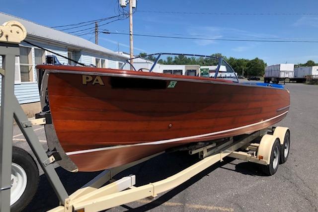Chris-Craft U-22 Sportsman 1946 Chris-Craft U-22 Sportsman wooden boat on trailer, parked outdoors.