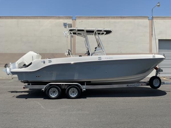 Bayliner Trophy T24CC 2025 Bayliner Trophy T24CC boat on trailer, side view, outdoors.