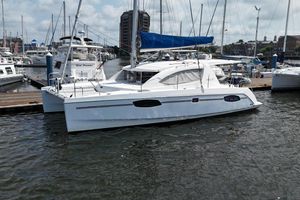 Leopard 39 Owner's Version 2012 Leopard 39 Owner's Version catamaran docked in a marina, featuring sleek design and blue sail.