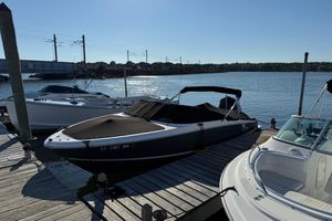Regal LX2 2021 Regal LX2 boat docked at a marina under clear blue skies.